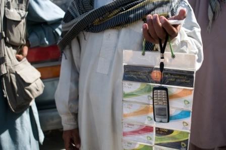 man holding nokia phone and mobile money uptions